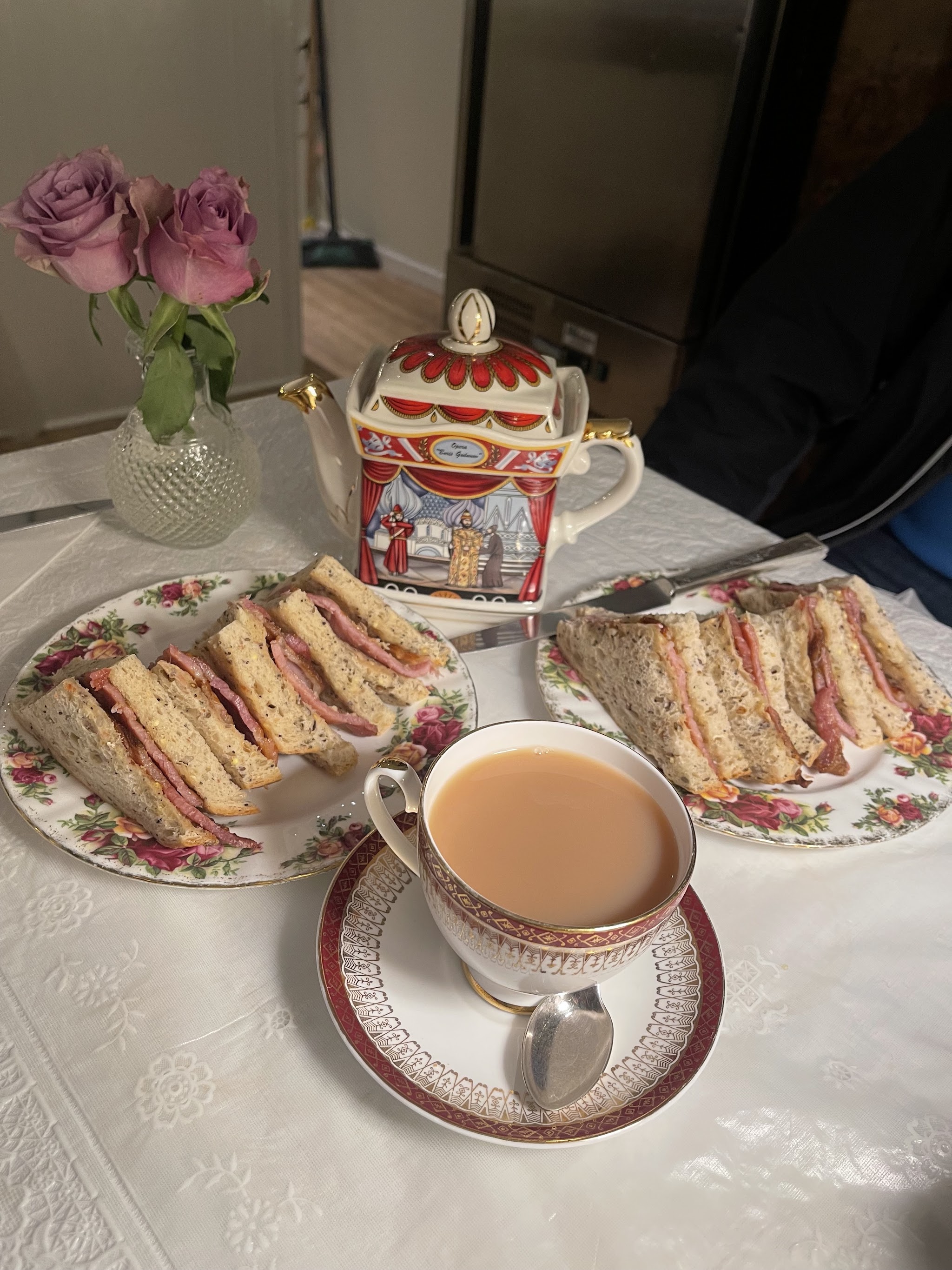Sandwiches served with tea in decorative china at Parisian Chic